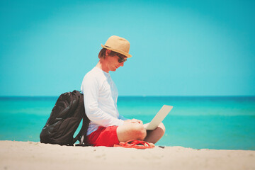 Wall Mural - man working on laptop at tropical beach