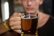 © WavebreakMediaMicro - Man holding a mug of beer in bar