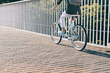 Slim Woman Rides A City Bike