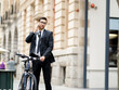 © Sergey Nivens - Young businessmen with a bike