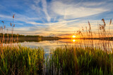 Fototapeta Zachód słońca - Scenic view of beautiful sunset above the pond