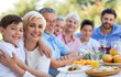 © pikselstock - Extended family eating outdoors