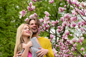 Wall Mural - romantic couple in love in spring garden at blooming magnolia