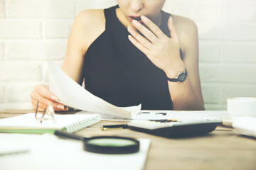 Amazed woman holding document