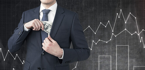 Canvas Print - Businessman putting money in pocket, graphs