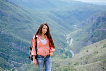 joyful woman travel mountains with backpack