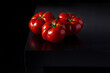 Juicy tomatoes on a wooden dark background