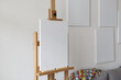 © Jordi Huisman - an empty canvas on an easel with multiple empty canvasses on the wall behind