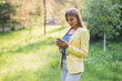 © dmshpak - Beautiful young business woman with a mobile phone in the park.