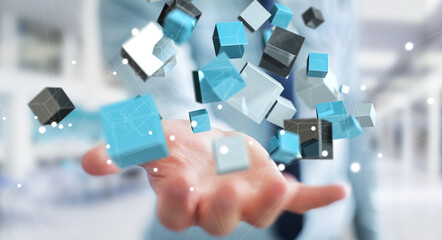 Fototapete - Businessman holding floating blue shiny cube network 3D rendering