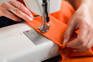 Sewing workshop. Stapling the material on the machine.