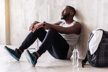 Calm bearded sportsman having rest time after training