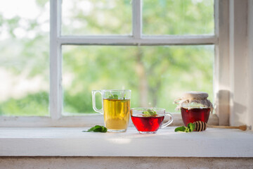 Poster - tea in glass cup on old  windowsill