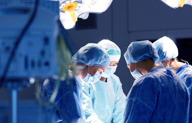 group of surgeons in operating room at hospital