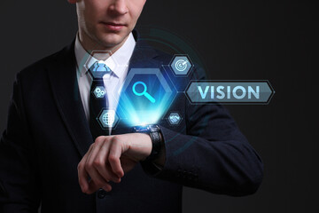 Business, Technology, Internet and network concept. Young businessman working on a virtual screen of the future and sees the inscription: Vision