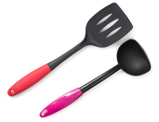 Black plastic kitchen spatula with red handle and black and pink ladle isolated on a white background, top view, close up.