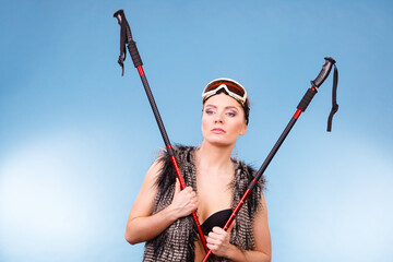 Poster - Woman wearing bra and holding ski poles