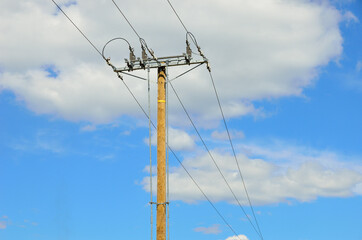 Electrical transmission pylon. Blue sky background.