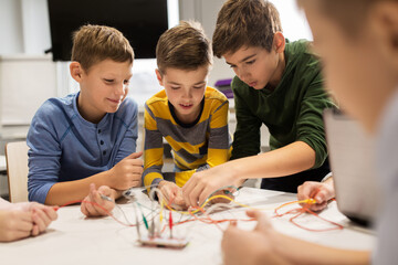 Wall Mural - happy kids with invention kit at robotics school