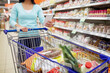 © Syda Productions - woman with food in shopping cart at supermarket