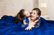 Mother and daughter hugging and looking at the camera. Happy loving family. Mother and daughter in beautiful long luxury blue dresses, makeup hairstyle. Fashion family portait. Generation relationship