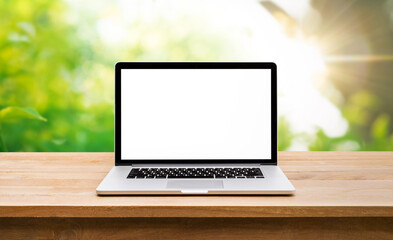 Wall Mural - Modern computer,laptop with blank screen on table with green garden background