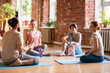 © Syda Productions - group of people resting on yoga mats at studio