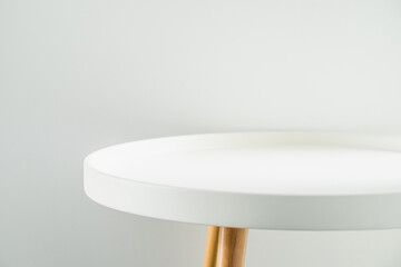empty modern round white table top at white house wall,mock up space for display or montage of produ