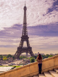 Fototapeta Paryż - A girl is looking at Eiffel tower,Paris