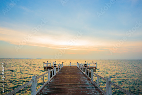 The wooden bridge on sea at sunset, Thailand.