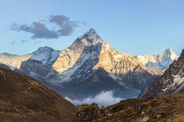 Wall Mural - ama dablam mountain at sunset and blue sky. sun illuminates slopes. himalayan mountains, nepal.