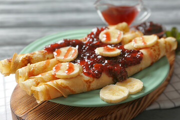 Wall Mural - Tasty pancakes with jam and bananas on plate