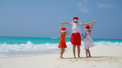 Sticker - Little girls and young mother in Santa Hats on beach Christmas vacation