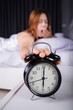 © geargodz - woman sleeping and wake up to turn off the alarm clock in morning