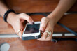 © fototrips - Close-up Of Woman Holding Mobile Phone ,girl using smartphone in cafe.   female hands typing text message via cellphone, social networking concept.