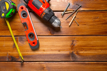 Assorted work tools on wood background