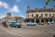 Bright wide-angle view of the daily life on one of the main streets in central Havana, Cuba with classic taxi cars passing the Capitolio and Gran Teatro de La Habana landmarks