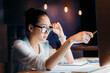 © LIGHTFIELD STUDIOS - concentrated asian businesswoman in eyeglasses pointing at computer monitor, working late at the office