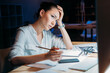 © LIGHTFIELD STUDIOS - young tired asian businesswoman in white blouse working till late in office