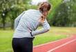 © leszekglasner - Woman on running track has side cramps during workout