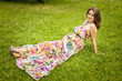© Yougen - Beautiful pregnant woman lies on a green lawn