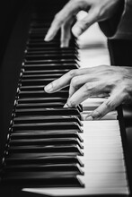 Male Musician Hands Playing On Piano Keys, Black And White. Music Background