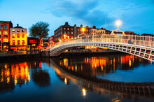 Dublin, Ireland. Night View Of Famous Illuminated Ha Penny Bridge
