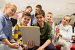 © Syda Productions - group of happy children with tablet pc at school