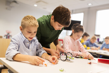 Wall Mural - happy children building robots at robotics school