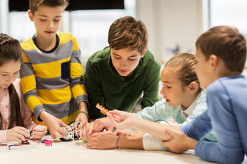 Wall Mural - happy children building robots at robotics school