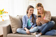 © Syda Productions - happy family with smartphone at home