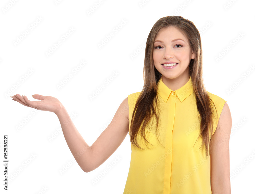 Beautiful young woman showing something on white background