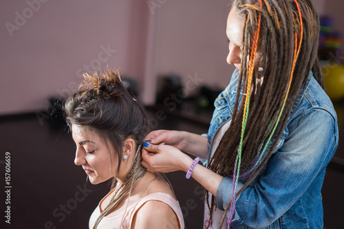 A Hair Stylist Braids Zizi Cornrows To A Young And Beautiful Girl