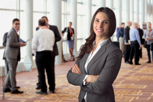 Fotografie, Obraz Happy business woman standing in crowd at workshop event with big genuine natura
